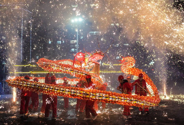People attend a “Wulong Xuhua” show to celebrate the Lantern Festival in Taijiang County, China, 11 February 2025 (issued 12 February 2025). The traditional “Wulong Xuhua” show is a genre of dragon dance performed amid fireworks by the Miao ethnic group. “Wulong” means the dragon dance, while “Xuhua” refers to a local specialty firework. Over 100 dragon dance teams gathered here to celebrate the Lantern Festival, the 15th day of the first month of the Chinese lunar calendar, which falls on 12 February this year. (Photo by Xinhua News Agency/EPA)