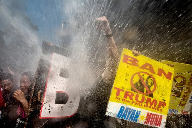 Protesters are soaked as they clash with riot police as they march the streets of Manila during the start of the ASEAN meetings between heads of state on November 13, 2017 in Manila, Philippines. Thousands of Filipinos protested in Manila as U.S. President Donald Trump's attended the ASEAN meetings in the Philippines, a stop included in his 12-day Asia trip. (Photo by Jes Aznar/Getty Images)