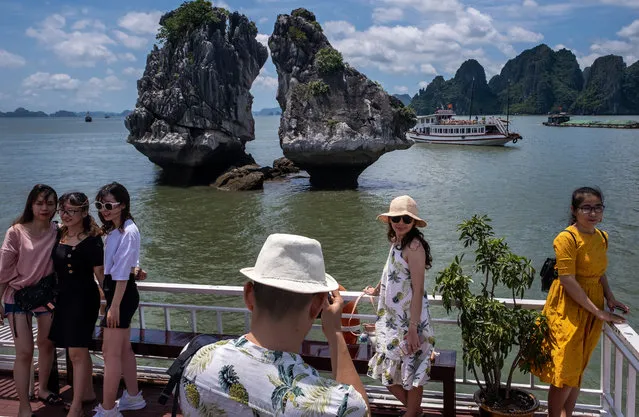 Vietnamese tourists pose for photographs on a boat touring Ha Long Bay, after the Vietnamese government eased the lockdown following the coronavirus disease (COVID-19) outbreak, on May 31, 2020 in Ha Long, Quang Ninh Province, Vietnam. Though some restrictions remain in place, Vietnam has lifted the ban on domestic travel, certain entertainment facilities and non-essential businesses to revive its economy. As of May 31, Vietnam has confirmed 328 cases of coronavirus disease (COVID-19 ) with no deaths in the country, 279 fully recovered and no new case caused by community transmission for 46 days. (Photo by Linh Pham/Getty Images)