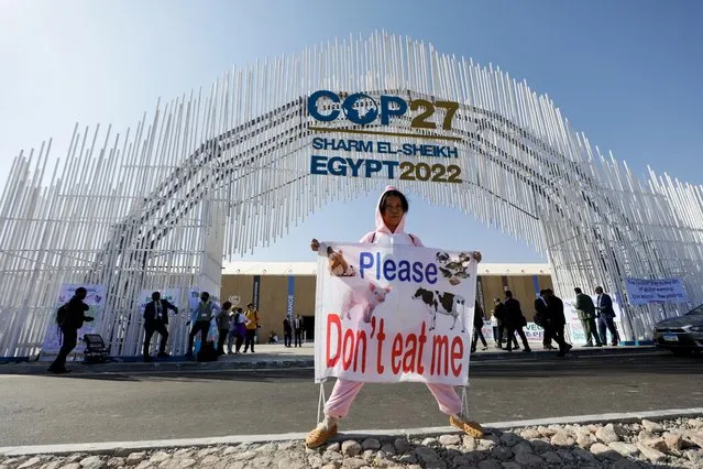An activist holds a banner, as she demonstrates at the entrance of the Sharm El Sheikh International Convention Centre, during the COP27 climate summit opening, in Sharm el-Sheikh, Egypt on November 7, 2022. (Photo by Mohamed Abd El Ghany/Reuters)