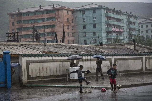 In this June 16, 2014 photo, boys play soccer in the town of Hyesan in North Korea's Ryanggang province. (Photo by David Guttenfelder/AP Photo)