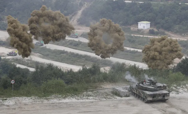 A South Korean Army's K1A2 tank shoots smoke screens during a live fire and maneuver demonstration for the media ahead of the Defense Expo Korea 2016 at the Seungjin Fire Training Field in Pocheon, South Korea, Tuesday, September 6, 2016. The Defense Expo Korea will be held in Goyang from Sept. 7 to Sept. 10. (Photo by Lee Jin-man/AP Photo)