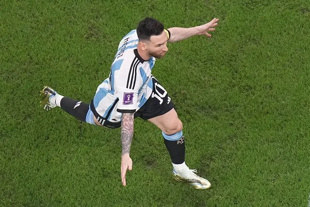 Argentina's Lionel Messi celebrates after scoring the opening goal during the World Cup round of 16 soccer match between Argentina and Australia at the Ahmad Bin Ali Stadium in Doha, Qatar, Saturday, December 3, 2022. (Photo by Pavel Golovkin/AP Photo)