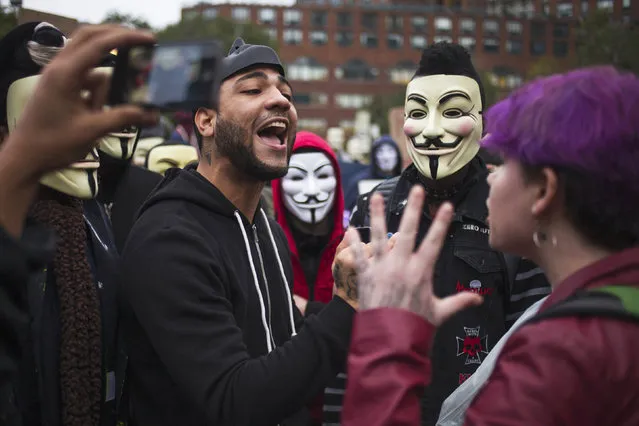 Activists, some wearing Guy Fawkes masks, debate with commuters during a demonstration in Union Square in Manhattan, New York November 5, 2014. (Photo by Adrees Latif/Reuters)