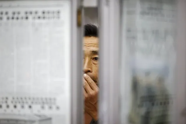 A man reads newspapers displayed inside a subway station visited by foreign reporters during a government organised tour in Pyongyang, North Korea, October 9, 2015. (Photo by Damir Sagolj/Reuters)