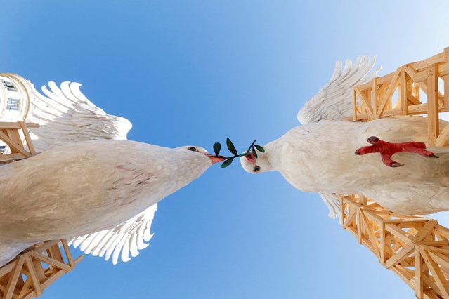 “Ninots” or giant figures, depicting doves of peace fighting over an olive branch by artist Escif, are displayed in the streets before being burned during the traditional annual Fallas festival, in Valencia, Spain, on March 15, 2024. (Photo by Eva Manez/Reuters)