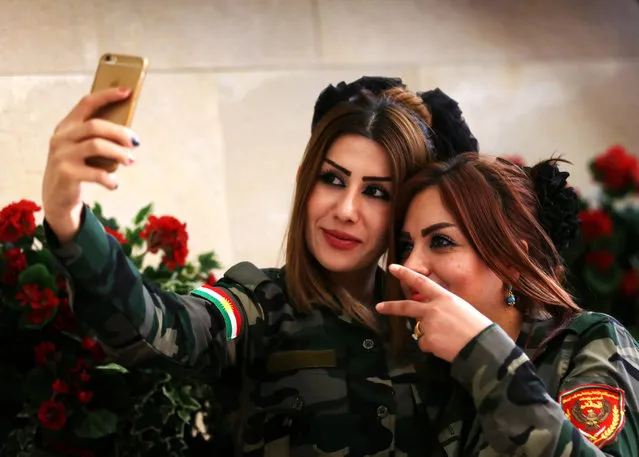 Female peshmegra fighters take a selfie in Arbil, the capital of the Kurdish autonomous region in northern Iraq, on June 9, 2015. (Photo by Safin Hamed/AFP Photo)