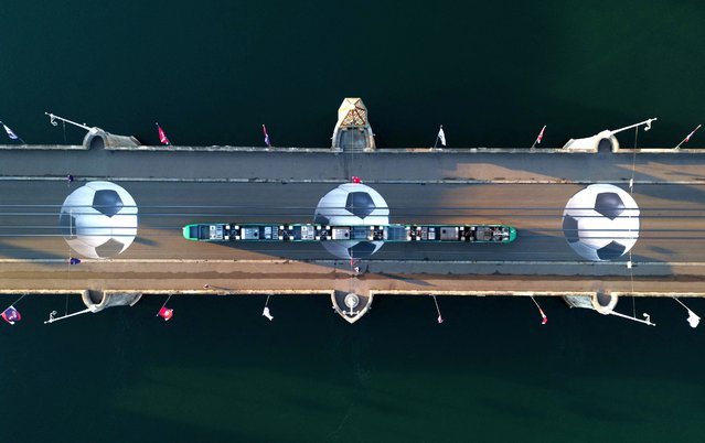 A drone view shows designs of giant footballs on the Mittlere bridge over the Rhine river ahead of the UEFA Women's Euro 2025, in Basel, Switzerland, on July 1, 2025. (Photo by Denis Balibouse/Reuters)
