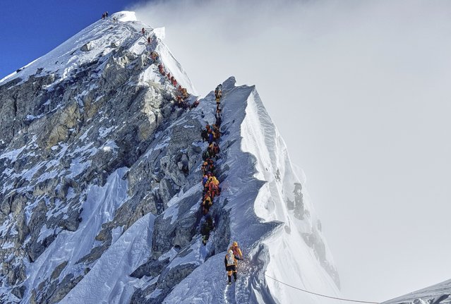 Mountaineers form a queue as they approach the summit of Mount Everest in Nepal, May 18, 2025. (Photo by Kunga Sherpa/AP Photo)