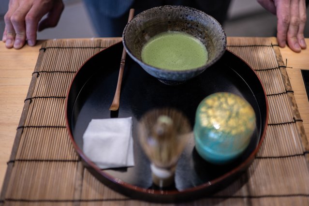 This picture taken on June 6, 2025 shows manager of Jugetsudo tea store Shigehito Nishikida making a bowl of matcha in Tokyo. With its deep grassy aroma, intense colour and pick-me-up effects, the popularity of matcha “has grown just exponentially over the last decade, but much more so in the last two to three years”, the 40-year-old explained. (Photo by Philip Fong/AFP Photo)