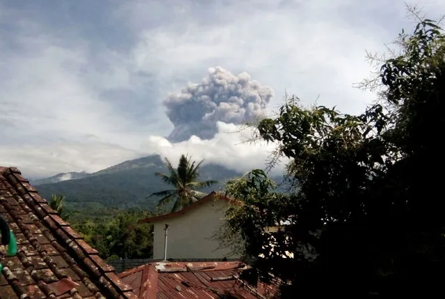 In this Tuesday, September 27, 2016 photo, volcanic material from the eruption of Mount Barujari is seen from Bayan, Lombok Island, Indonesia. The volcano erupted without warning on Tuesday afternoon, delaying flights from airports on the islands of Lombok and Bali. (Photo by Denda Wiyana Putri/AP Photo)