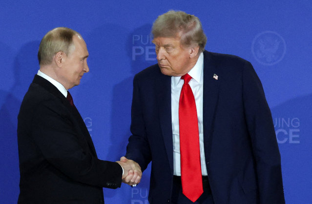 U.S. President Donald Trump and Russian President Vladimir Putin shake hands during a press conference following their meeting to negotiate an end to the war in Ukraine, at Joint Base Elmendorf-Richardson in Anchorage, Alaska, on August 15, 2025. (Photo by Jeenah Moon/Reuters)