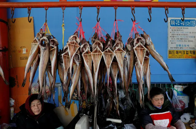 Street vendors selling dried fish wait for customers at a local market in Gangneung, South Korea February 20, 2018. (Photo by Murad Sezer/Reuters)