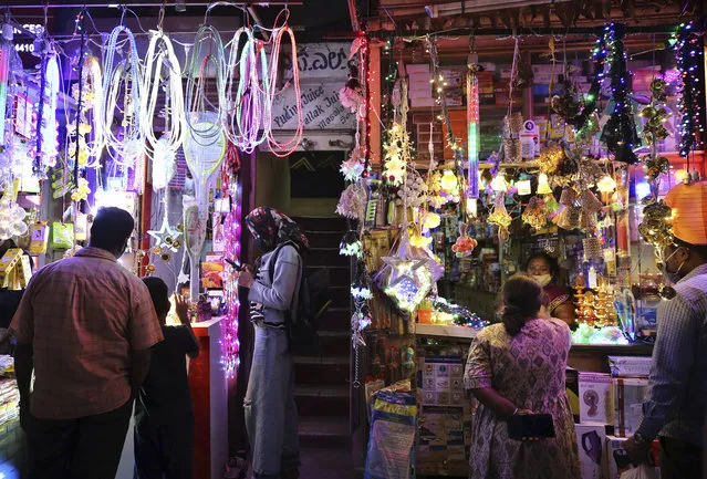 Indians shop for lights at a market ahead of Hindu festival Diwali in Bengaluru, India, Thursday, November 12, 2020. (Photo by Aijaz Rahi/AP Photo)
