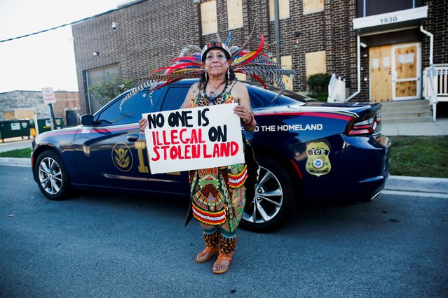 Wearing a Mexica traditional garment, Rosa Gayton, poses for a portrait while holding a sign “No One is Illegal on Stolen Land”, outside an ICE facility, days after U.S. President Donald Trump ordered increased federal law enforcement presence and stepped-up immigration enforcement actions by the Department of Homeland Security, in Broadview, Illinois, U.S., September 14, 2025. (Photo by Octavio Jones/Reuters)
