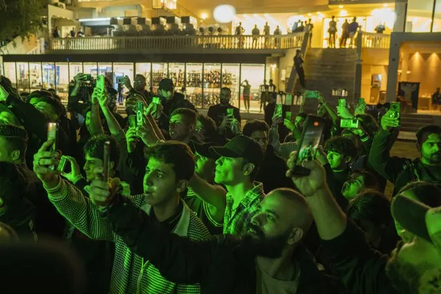 Youths gather along the Tigris River for a concert by rap artist OG Khalifa in Baghdad, Iraq, Saturday February 25, 2023. One of the songs he performed mocks “sheikhs”, those who wield power in the new Iraq through wealth or political connections. (Photo by Jerome Delay/AP Photo)
