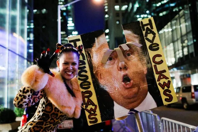 A woman takes part in a protest against Republican presidential nominee Donald Trump and the GOP in front of Trump Tower in Manhattan, New York City, U.S., October 19, 2016. (Photo by Brendan McDermid/Reuters)