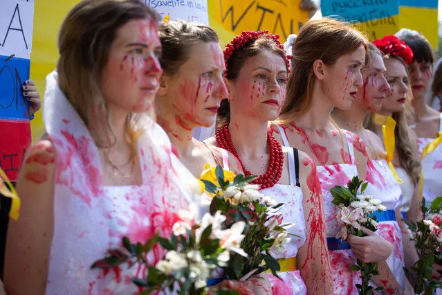 Ukrainian women dressed as brides and painted with fake bloods gather during protest against Russia's intervention in Ukraine, outside of the Russian embassy, in Mexico City, Mexico on February 26, 2022. (Photo by Daniel Cardenas/Anadolu Agency via Getty Images)