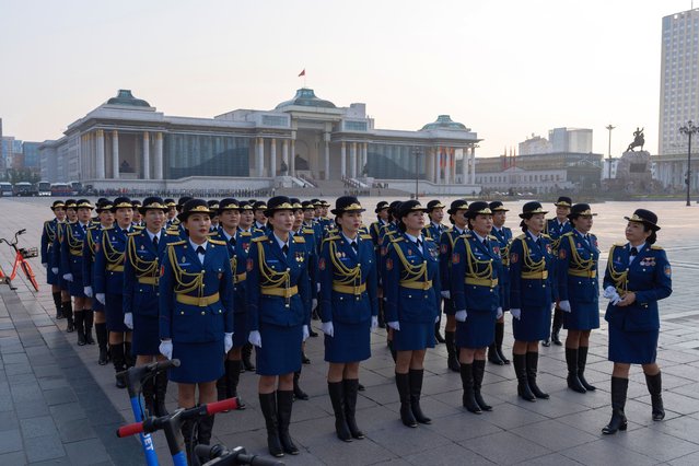 Mongolian women in uniforms rehearse for the upcoming National Flag Day outside the Government Palace on Sukhbaatar Square in Ulaanbaatar, Mongolia, Wednesday, July 3, 2024. (Photo by Ng Han Guan/AP Photo)