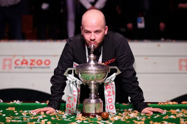  Luca Brecel of Belgium celebrates with the Cazoo World Snooker Championship trophy following victory in the Final match against Mark Selby of England on Day Sixteen of the Cazoo World Snooker Championship 2023 at Crucible Theatre on May 01, 2023 in Sheffield, England. (Photo by George Wood/Getty Images)