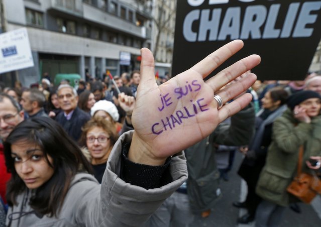 A woman with “I'm Charlie” written on her hand takes part in a Hundreds of thousands of French citizens solidarity march (Marche Republicaine) in the streets of Paris January 11, 2015. French citizens will be joined by dozens of foreign leaders, among them Arab and Muslim representatives, in a march on Sunday. (Photo by Yves Herman/Reuters)