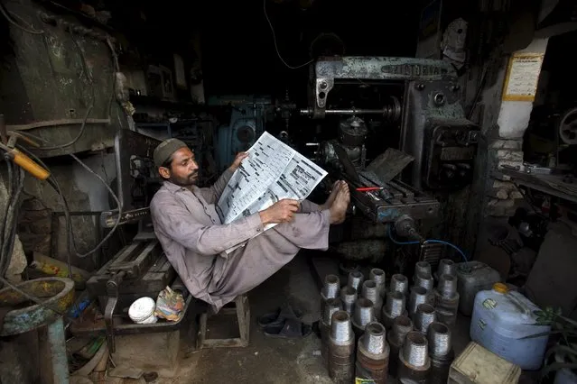 A worker takes a break from his work during a power cut at a workshop on the outskirts of Peshawar, Pakistan, November 5, 2015. Pakistan's government, struggling to fulfil election promises to end daily power cuts, is shifting from big generation projects to less splashy reforms including new transmission systems, privatisation and better management. (Photo by Fayaz Aziz/Reuters)