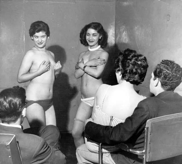 circa 1955:  Two prostitutes perform a strip show for prospective clients in Santiago, Chile.  (Photo by George Pickow/Three Lions/Getty Images)