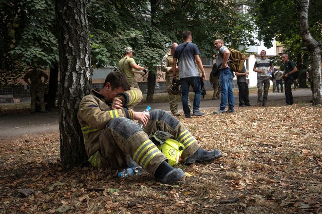 A Ukrainian emergency serviceman waits for an air raid siren to subside before resuming work at the site of a Russian missile strike in Poltava, Ukraine, on Wednesday, September 4, 2024. The strike, which targeted a military educational facility in central Ukraine, killed 51 people and injured more than 200 others, according to Ukrainian offiicias, in one of the deadliest single attacks since the start of Moscow’s full-scale invasion in February 2022. (Photo by Patryk Jaracz/Anadolu via Getty Images)
