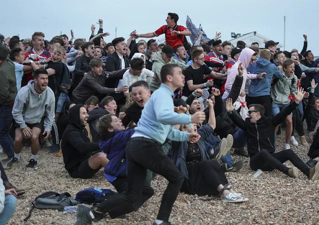The crowd watching the match at Lunar cinema on Brighton beach react to Englands Harry Kane as he scores the winner as England play Tunisia in the group stages of the 2018 FIFA World Cup tournament on June 18, 2018 in Brighton, England. (Photo by Alan Crowhurst/Getty Images)