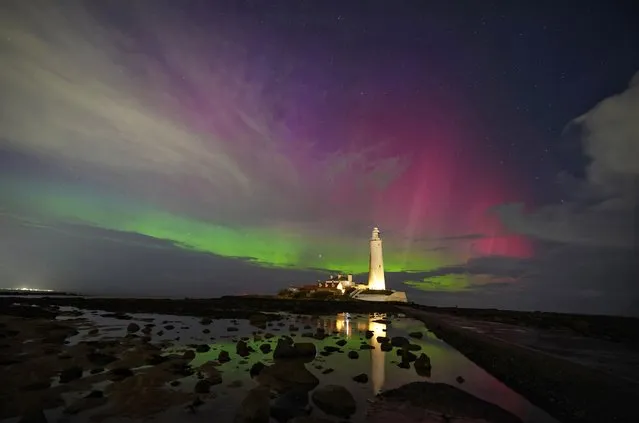 The aurora borealis, also known as the northern lights, glow on the horizon at St Mary's Lighthouse in Whitley Bay on the North East coast on Thursday, March 23, 2023. (Photo by Owen Humphreys/PA Wire)