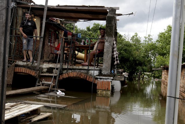 Houses are partially submerged in flood waters in Asuncion, December 20, 2015. (Photo by Jorge Adorno/Reuters)
