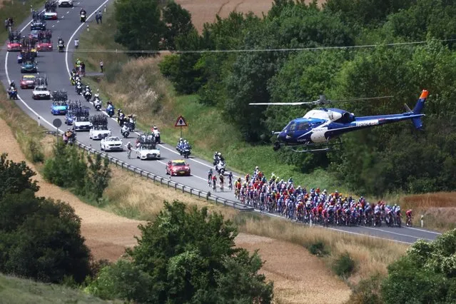 A helicopter hovers over the peloton during the second stage of the Tour de France 2023 over 208.9km from Vitoria-Gasteiz to San Sebastian, Spain, 02 July 2023. (Photo by Martin Divisek/EPA)