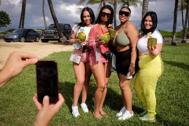 Women pose for a photo in Ocean Drive during spring break festivities, amid the coronavirus disease (COVID-19) outbreak in Miami Beach, Florida, U.S., March 6, 2021. (Photo by Marco Bello/Reuters)