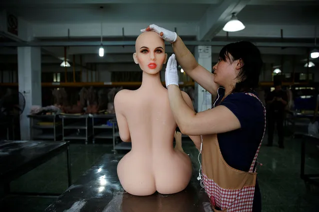 A worker assembles a s*x doll at the WMDOLL factory in Zhongshan, Guangdong Province, China, July 11, 2018. The factory has over 200 full-time workers, all dolls are handmade and each requires the cooperation of at least five workers. (Photo by Aly Song/Reuters)
