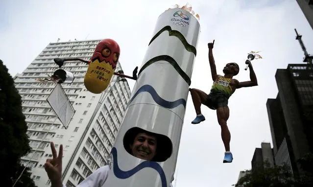 A runner is dressed in a costume depicting the Rio 2016 Olympic torch, decorated with a figure of Jamaicaâ€™s Usain Bolt and a pill, before the annual "Sao Silvestre Run" (Saint Silvester Road Race), an international race through the streets of Sao Paulo, Brazil, December 31, 2015. The runner says the pill represents his hope for an Olympics that is free of doping and the figure of Bolt embodies his wish to see the Jamaican in the 200-metre race. (Photo by Nacho Doce/Reuters)