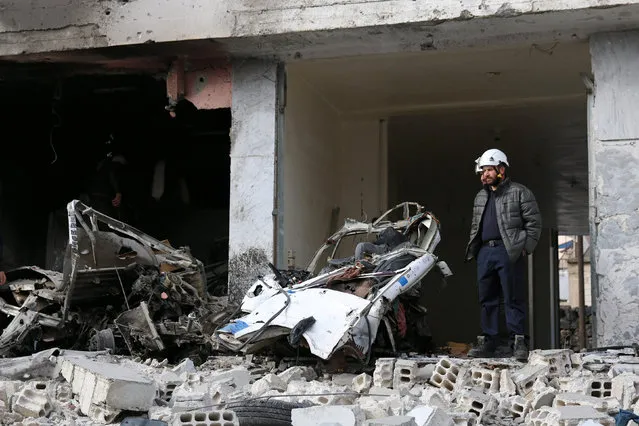 Civil defence members stand amid the damage at a market hit by an airstrike in the rebel-held Jasim city, in Deraa Governorate, Syria November 23, 2016. (Photo by Alaa Al-Faqir/Reuters)