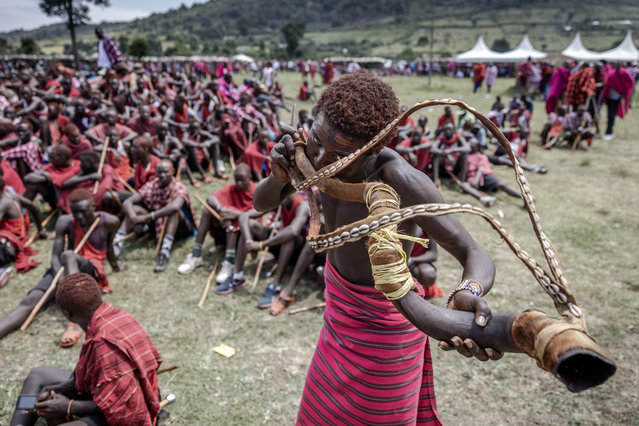 A young Maasai man plays a traditional horn during the Eunoto ceremony in a remote area near Kilgoris, Kenya on August 18, 2023. (Photo by Luis Tato/AFP Photo)