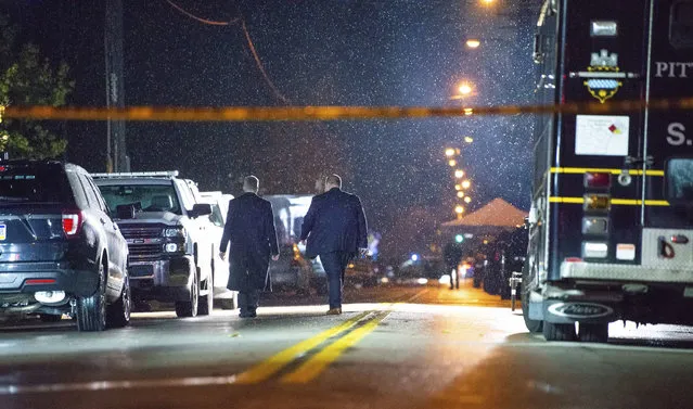 The FBI investigates in the rain after an active shooter situation at the Tree of Life Congregation on Saturday, October 27, 2018, in the Squirrel Hill section of Pittsburgh. A gunman opened fire at the synagogue, killing multiple people and injuring others in one of the deadliest attacks on Jews in U.S. history. (Photo by Andrew Stein/Pittsburgh Post-Gazette via AP Photo)
