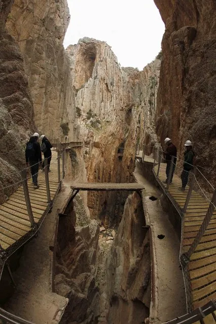 Journalists walk along the new Caminito del Rey (The King's Little Pathway) in El Chorro-Alora, near Malaga, southern Spain March 15, 2015. (Photo by Jon Nazca/Reuters)