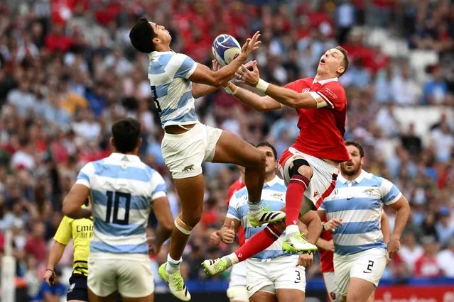 Argentina's outside centre Lucio Cinti (2L) and Wales' full-back Liam Williams (2R) leap for a high ball during the France 2023 Rugby World Cup quarter-final match between Wales and Argentina at the Stade Velodrome in Marseille, south-eastern France, on October 14, 2023. (Photo by Christophe Simon/AFP Photo)