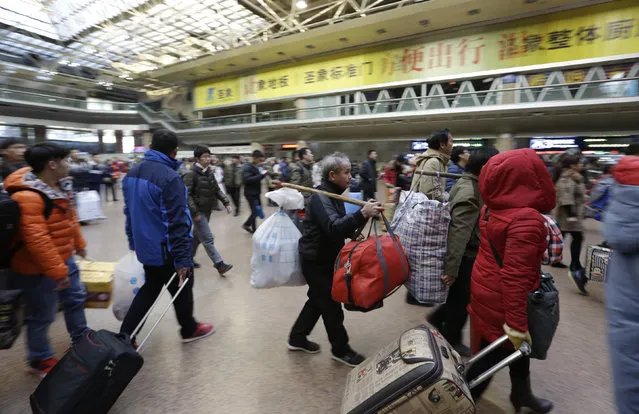 Passengers carry luggages as they enter the waiting hall of the Beijing West Railway Station, China, February 1, 2016. (Photo by Jason Lee/Reuters)
