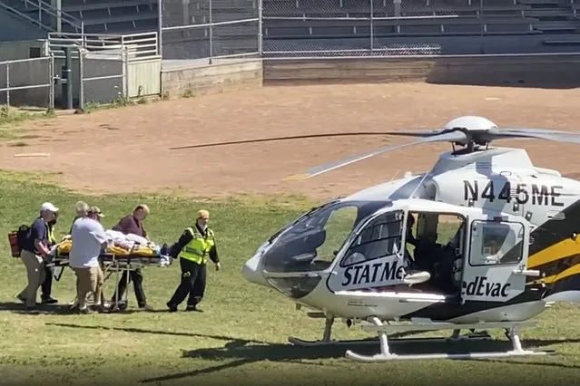 In this still image from video, author Salman Rushdie is taken on a stretcher to a helicopter for transport to a hospital after he was attacked during a lecture at the Chautauqua Institution in Chautauqua, N.Y., Friday, Aug. 12, 2022. (Photo by AP Photo/Stringer)
