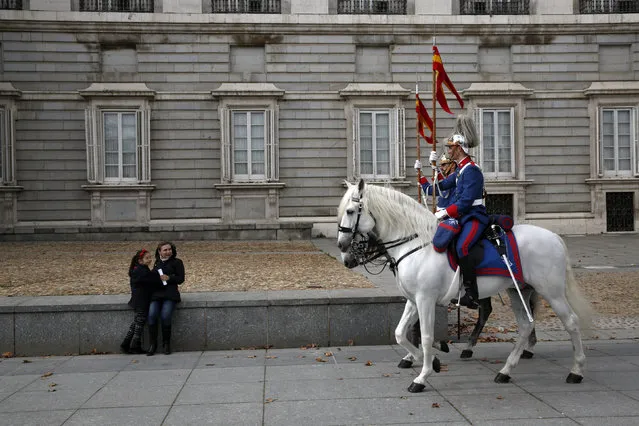 Mounted members of the Royal Guard ride outside the Royal Palace in Madrid, Spain, February 10, 2016. (Photo by Susana Vera/Reuters)