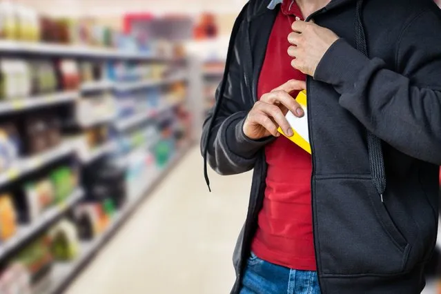 Retail shoplifting. Man stealing in supermarket. Theft at shop. (Photo by Andrey Popov/Getty Images)