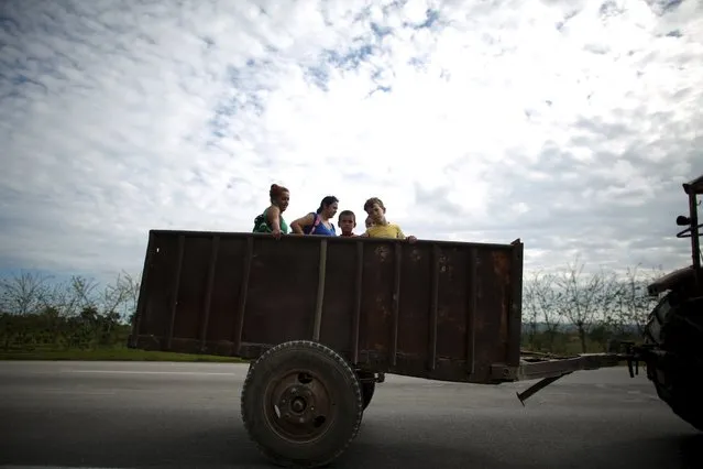 Sara Carcache, 40, not pictured, drives her 1970 Ukrainian made tractor as she takes children and their mothers from school in Caimito, Cuba, February 15, 2016. (Photo by Alexandre Meneghini/Reuters)