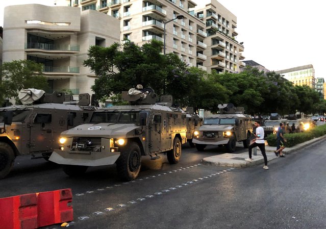 Police armored vehicles are deployed after clashes between security forces and protesters outside the home of Prime Minister-designate Najib Mikati in Beirut, following a fuel tank explosion in northern Lebanon, August 15, 2021. (Photo by Issam Abdallah/Reuters)
