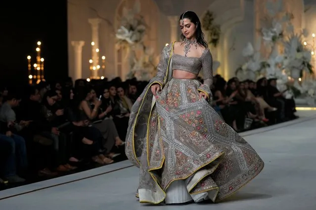 A model presents a creation from designer Fahad Hussayn during a fashion show of Bridal Couture Week in Lahore, Pakistan, Friday, December 15, 2023. (Photo by K.M. Chaudary/AP Photo)