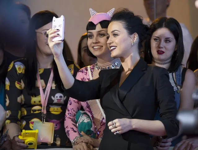 Singer Katy Perry takes a selfie with a fan at the premiere screening of “Katy Perry: The Prismatic World Tour” in Los Angeles, California March 26, 2015. (Photo by Mario Anzuoni/Reuters)