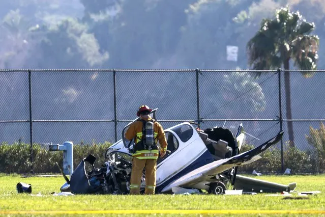 A first responder stands near a single-engine plane that crashed onto a soccer field Monday, September 25, 2023, in San Pedro, California. The crash critically injured both people aboard the aircraft. The crash was reported in the 400 block of West Westmont Drive at 12:53 p.m., according to Margaret Stewart of the Los Angeles Fire Department. (Photo by Jay L. Clendenin/Los Angeles Times via Getty Images)