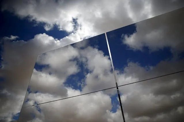 Heliostat mirrors reflect the sky in a field at the construction site of a 240 meter (787 feet) solar-power tower in Israel's southern Negev Desert, February 8, 2016. The world's tallest solar-power tower is being built off a highway in the Negev Desert in southern Israel, its backers hoping the technology will gain a foothold in the solar market even if it remains a small player for now. (Photo by Amir Cohen/Reuters)